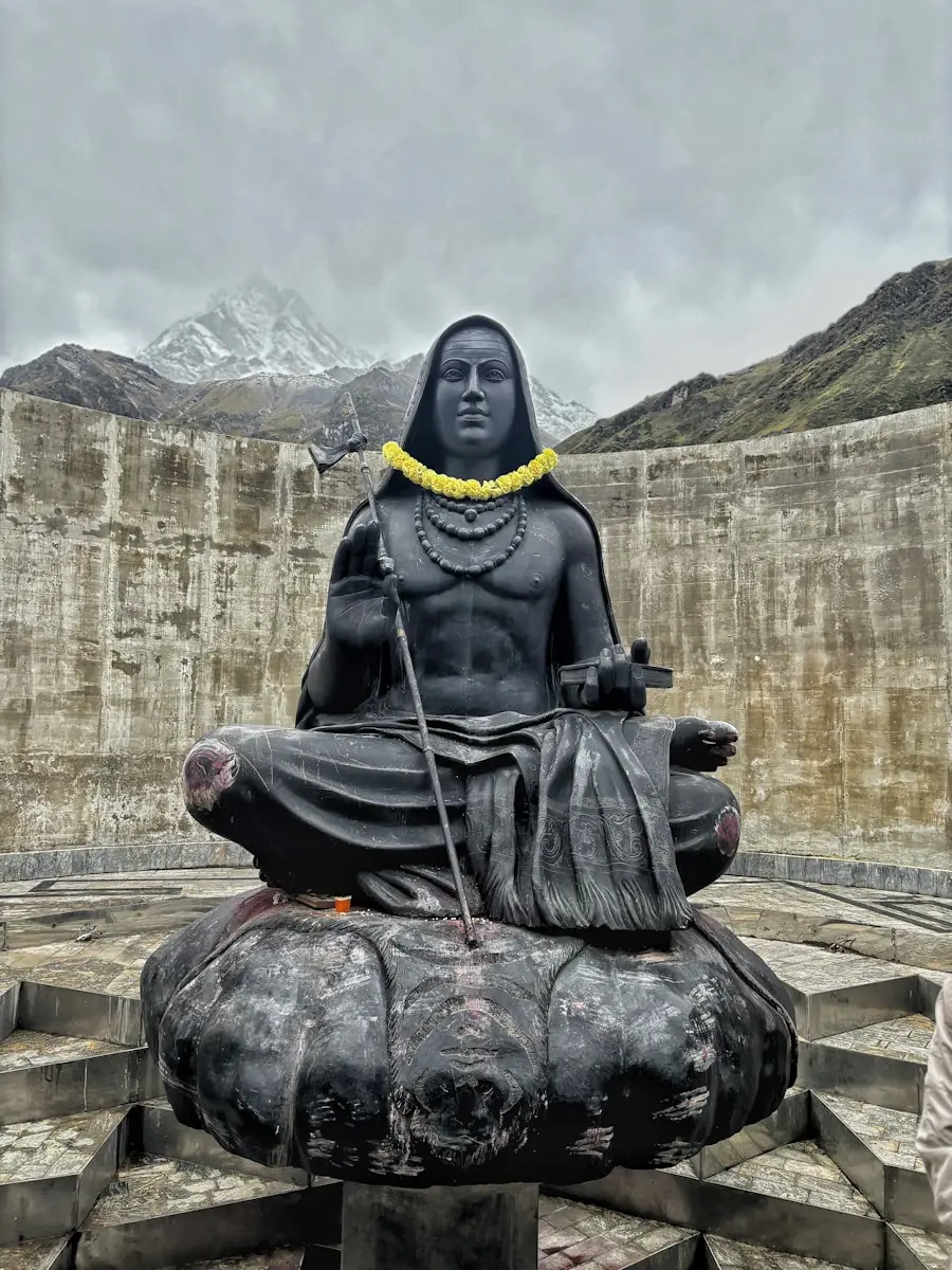 A statue of buddha sitting on top of a stone structure